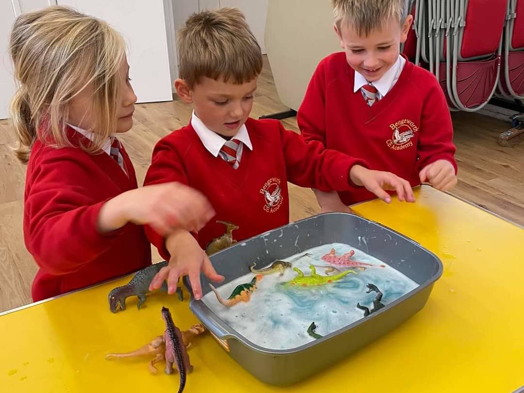 Children washing dinosaurs